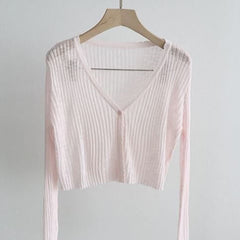 Light pink knitted cardigan in a short style