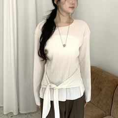 An elasticated waistband and pleated texture long-sleeved top