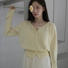 Soft cream-colored knitted cardigan top