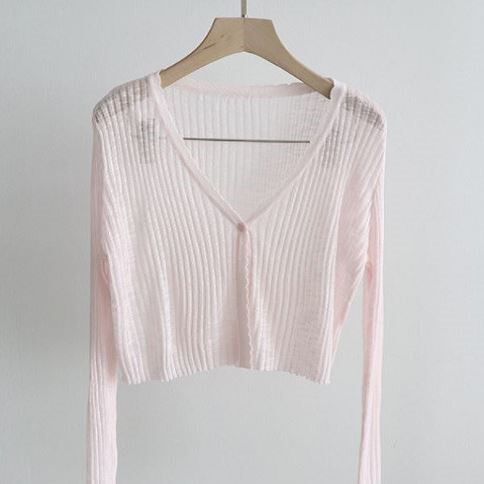 Light pink knitted cardigan in a short style
